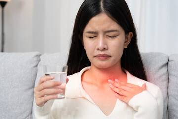 Asian woman put on neck due to a sore throat. female tonsillitis causes a inflammation. treated by...