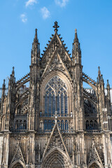 Gothic Facade of German Cologne Cathedral Against Blue Sky. Unesco World Heritage Site in Germany.