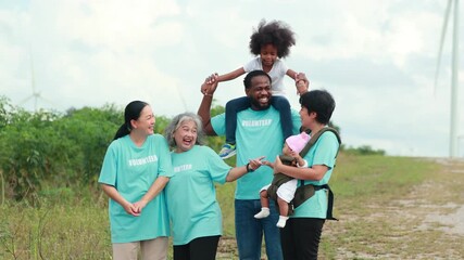 Volunteers are walking behind a windmill farm, volunteer charity people. charity community service event, ngo business and outreach, Group Diverse people meeting at park for donation