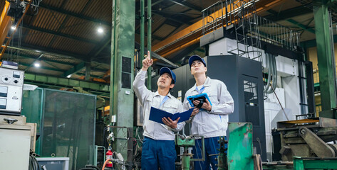 A group of workers inspecting a factory
