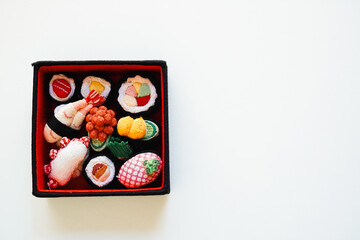 Overheard shot of Assortment of Fabric-Crafted Sushi, copy space 
