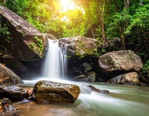 A sunlit waterfall cascades over mossy rocks into a flowing stream, surrounded by lush green forest and boulders. Tranquil scene with light