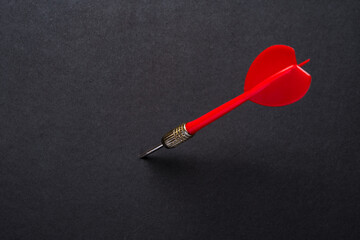 Red dart arrow on black  background	