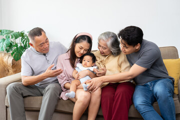A multigenerational family gathers together, sharing warmth and love as they celebrate a special family moment with newborn. Their care strengthen bond between generations, embracing positive emotions