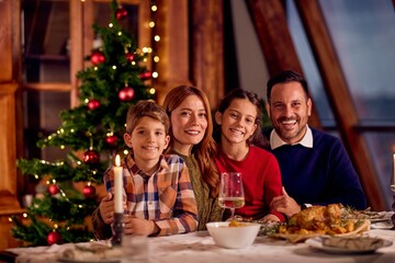 Joyful Family Dinner Celebration With Christmas Tree, Warm Candles, And Roasted Dinner Together In Cozy Home
