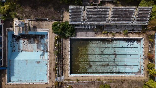 Abandoned swimming pool reveals nature's takeover in a forgotten place - panning motion