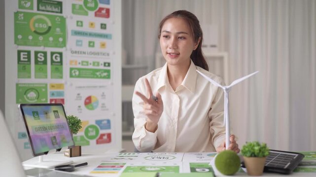 Asian woman businesswoman discussing green business strategies renewable energy ESG sustainability at modern office desk - Powered by Adobe