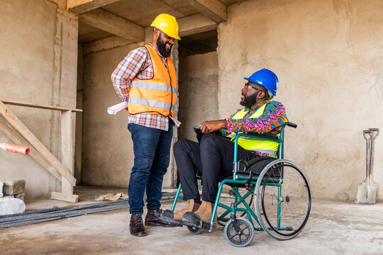 Disability and inclusion, Two African construction engineers collaborate on a project inside a building site, one seated in a wheelchair showcasing teamwork and innovation