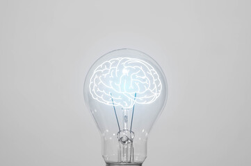 A lightbulb glowing with a brain inside symbolizes intelligence, innovative thinking, knowledge, mental power, and smart decision-making.