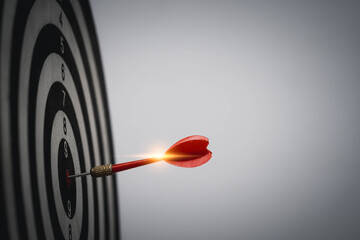 Red dart hitting bullseye with glowing light flare symbolizes powerful focus, strategic success, precise goal achievement, business breakthrough, and inspirational momentum.