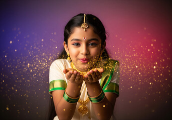 Bal Lakshmi child blowing gold glitter in traditional Kerala attire, cream white dress with green border, gold jewelry, violet and magenta background, soft light and shimmering particles mid air