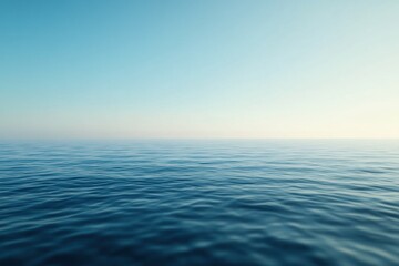Fototapeta premium Infinite Horizon: A serene and expansive vista of a calm ocean merges seamlessly with a tranquil sky. The water's surface gently ripples under a gradient of light.
