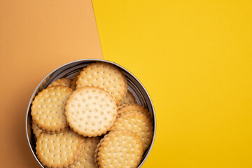 Cookies in a metal box on a light background. Homemade cookies in eco-friendly packaging. Composition for branding, delivery, or catering concepts. Sweet snack.