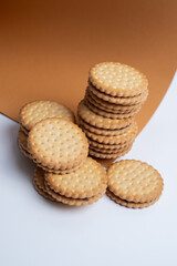 Sandwich cookies, cookies with chocolate cream filling in a crust. A modern cookie and packaging concept. A sweet snack and holiday concept.