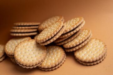 Sandwich cookies, cookies with chocolate cream filling in a crust. A modern cookie and packaging concept. A sweet snack and holiday concept.