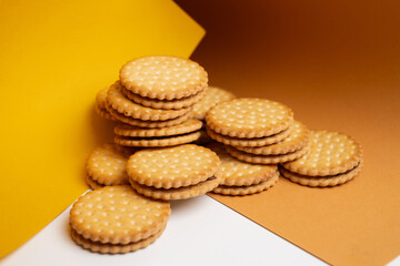 Sandwich cookies, cookies with chocolate cream filling in a crust. A modern cookie and packaging concept. A sweet snack and holiday concept.
