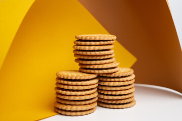 Sandwich cookies, cookies with chocolate cream filling in a crust. A modern cookie and packaging concept. A sweet snack and holiday concept.