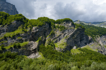 This landscape photo was taken in Europe, France, Auvergne-Rhone-Alpes, Haute-Savoie, Sixt-Fer-a-Cheval, in summer. It shows the rocky peaks in the Cirque du Fer-a-Cheval, under the Sun.