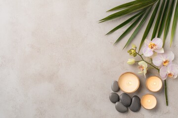 Minimalist spa background with candles, gray pebbles, palm leaves, and orchids on light stone surface, ideal for wellness advertisements, relaxation themes, and beauty treatment designs