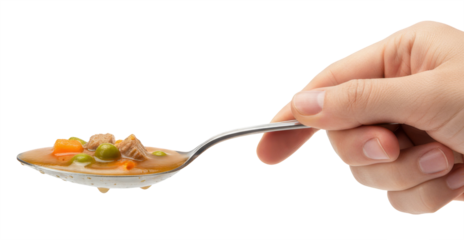 a hand holds a silver spoon with hearty meat, vegetable, and broth soup