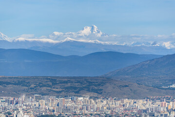 Cityscape view of Tbilisi, the capital of Georgia with snow-capped Caucasus mountains in the distance