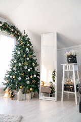 Christmas tree in the interior of a bright living room. The attic. Daytime