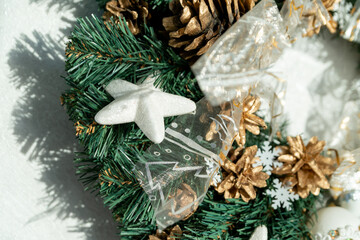 A white star on a Christmas wreath made of spruce.  Christmas decorations.