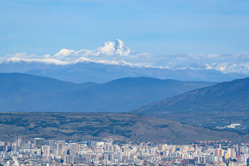 Cityscape view of Tbilisi, the capital of Georgia with snow-capped Caucasus mountains in the...