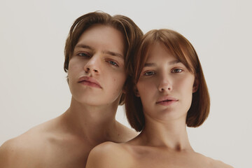 Confident couple with natural bare skin showing skincare perfection. Concept of advanced skincare, healthy complexion, aesthetic clarity representing trust, balance, and refinement.