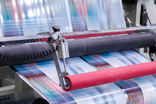 new innovative technology of automatic label printing machine with digital control panel. printing on continuous plastic film for wrapping on food product packaging in the printing factory.