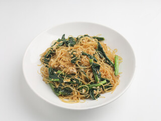 Fried rice noodles and vegetables on wooden background