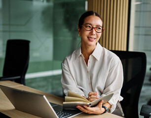 Portrait of a young businesswoman  or a young entrepreneur or a student young woman working on...