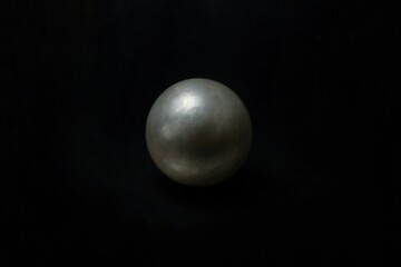 Metallic sphere on dark background.