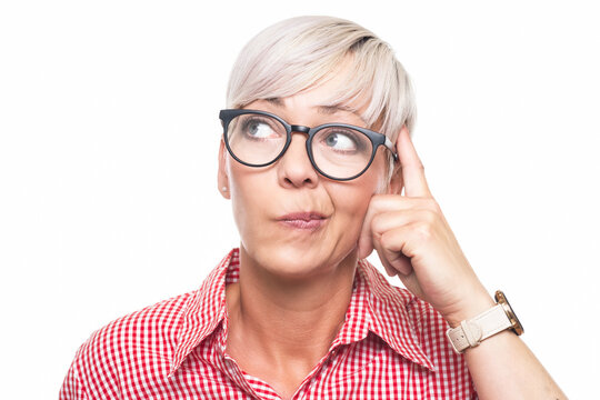Crafty adult woman thinking. Closeup portrait of smart person looking for inspiration, copy space for text, isolated on white background. Thoughtful middle aged woman looking up.