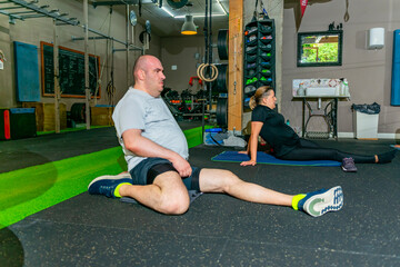 Adults stretching on gym floor for warm up
