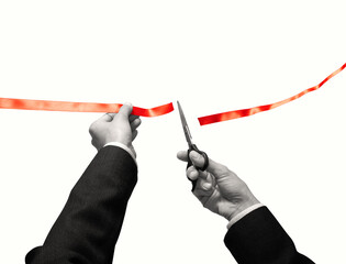 Scissors in hands cuts the red satin ribbon and colorful paper confetti is falling. Isolated on white background.