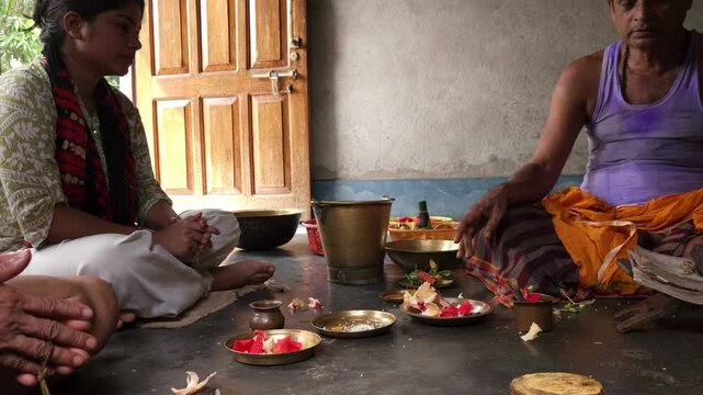 Close-up of Shivling pooja with milk, flowers, and bael leaves being offered. Indian people performing sacred havan on the occasion of Mahashivratri, offering ghee to the holy fire during  Vedic puja.