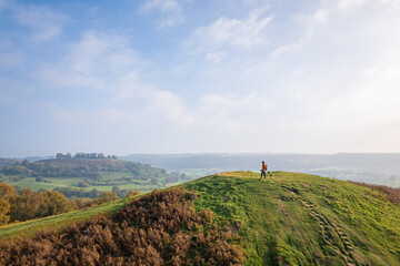Hiker on the hill in Cotswolds, near Dursley and Uley. Autumn Travel in United Kingdom