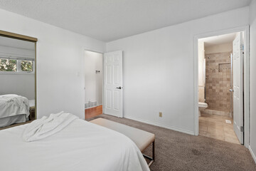 Bedroom with a white bed and a white door