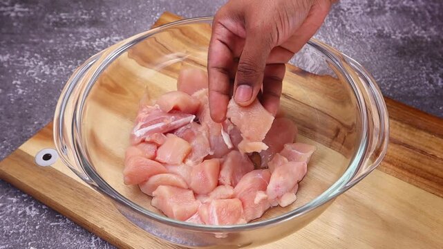 Boneless chicken pieces marinating in a rich blend of aromatic spices, ready to absorb all the flavors before cooking.