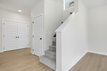 White staircase leading to a white door
