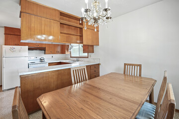 Wooden dining table with four chairs around it