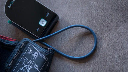 Digital Blood Pressure Monitor on Gray Fabric Surface