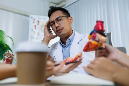 A doctor and a nurse are examining a model of a heart. The doctor is explaining the anatomy of the heart to the nurse
- Powered by Adobe