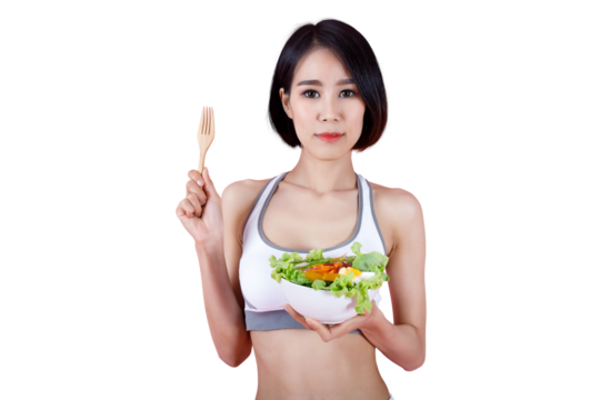 Healthy young woman in sportswear holding a bowl of fresh salad and wooden fork on pink background, promoting clean eating and healthy lifestyle concept.