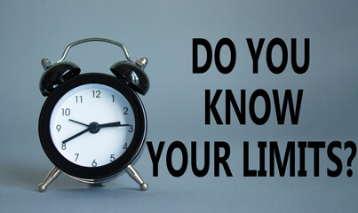 Do You Know Your Limits symbol. Beautiful grey background with alarm clock. Business and Do You Know Your Limits concept. Copy space.