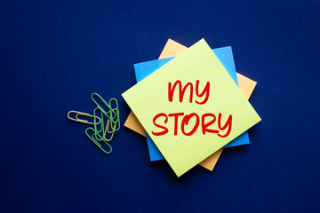 My story symbol. Yellow sticky note with words My story. Beautiful deep blue background. Business and My story concept. Copy space.