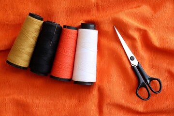 Sewing threads, scissors, and fabrics. Sewing concept.