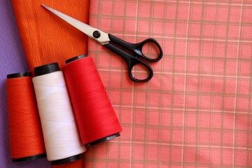 Sewing threads, scissors, and fabrics. Sewing concept.
