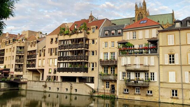 Metz, France, old town houses at the river Mosel and view to the Cathedral